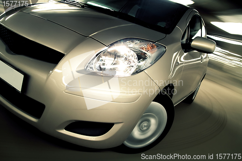 Image of Car driving fast in parking house