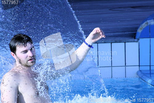 Image of water splash on man face  