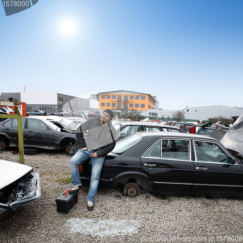 Image of man looking for car parts