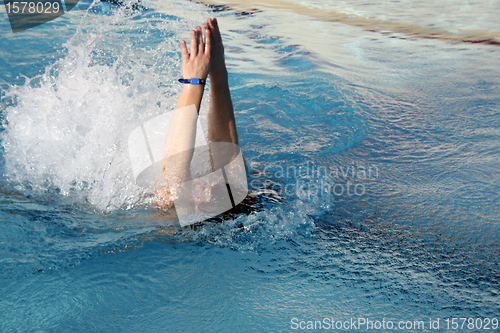 Image of young man swimming backstroke