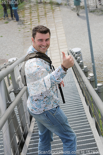 Image of laughing man showing thumbs up