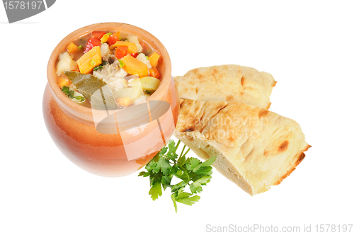 Image of Roast in a pot and pita bread