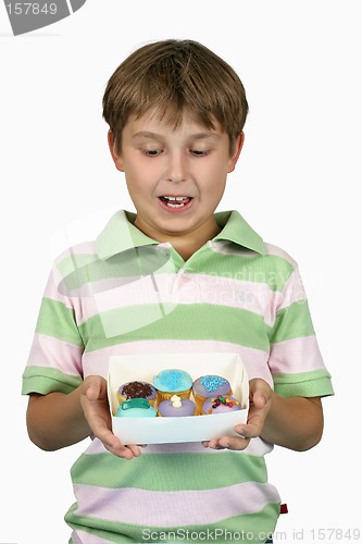 Image of Child holding yummy cupcakes
