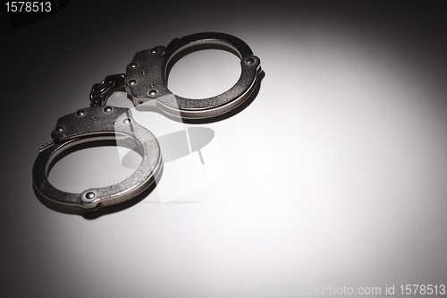 Image of Abstract Pair of Handcuffs Under Spot Light - Text Room