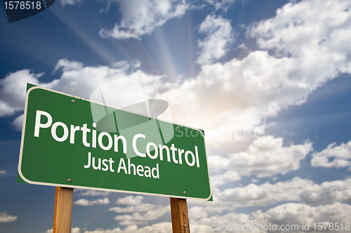 Image of Portion Control Just Ahead Green Road Sign and Clouds