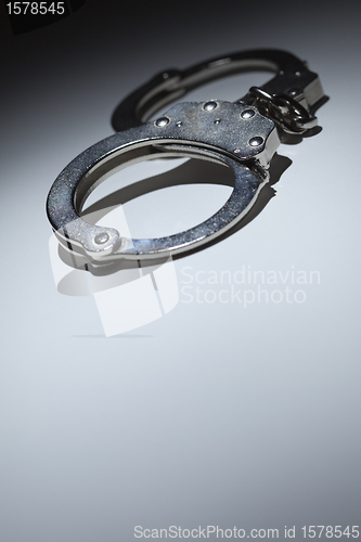 Image of Abstract Pair of Handcuffs Under Spot Light - Text Room