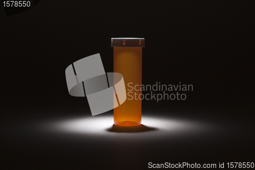 Image of Empty Medicine Bottle Under Spot Light