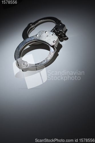 Image of Abstract Pair of Handcuffs Under Spot Light - Text Room