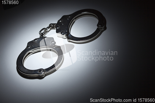 Image of Abstract Pair of Handcuffs Under Spot Light - Text Room