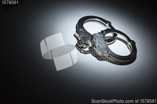 Image of Abstract Pair of Handcuffs Under Spot Light - Text Room