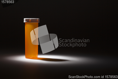 Image of Empty Medicine Bottle Under Spot Light