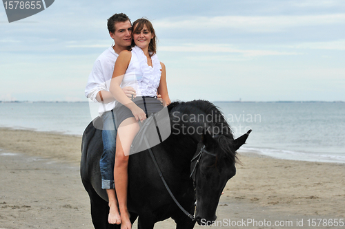 Image of couple and  horse on the beach