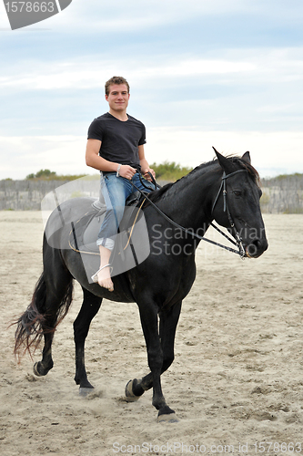 Image of young man and horse