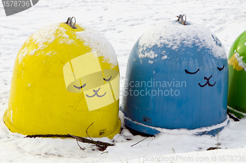 Image of anow cover plastic bins for sort waste in winter 