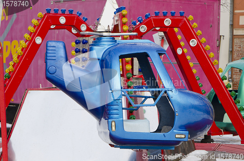 Image of amusement park rides colorful carousel spin helicopter 