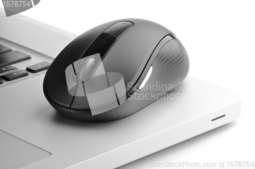 Image of Steel laptop and black computer mouse 