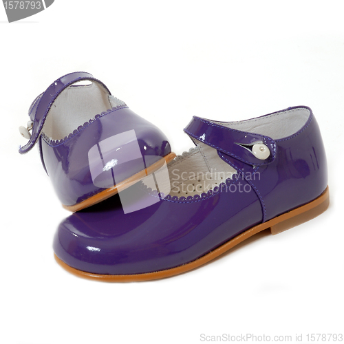 Image of little girl violet shoes isolated 