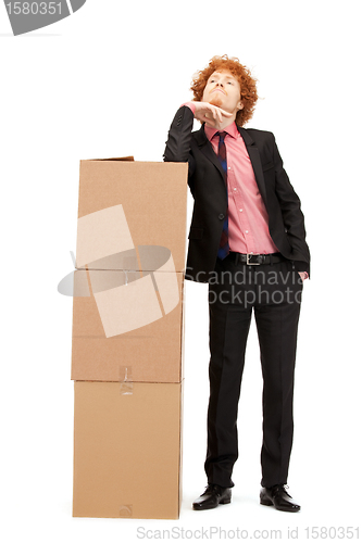 Image of attractive businessman with big boxes