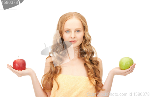 Image of young beautiful woman with green and red apples