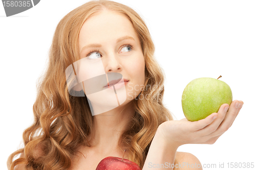 Image of young beautiful woman with green and red apples