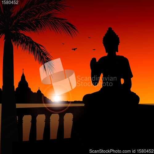 Image of statue of buddha with temple at the background