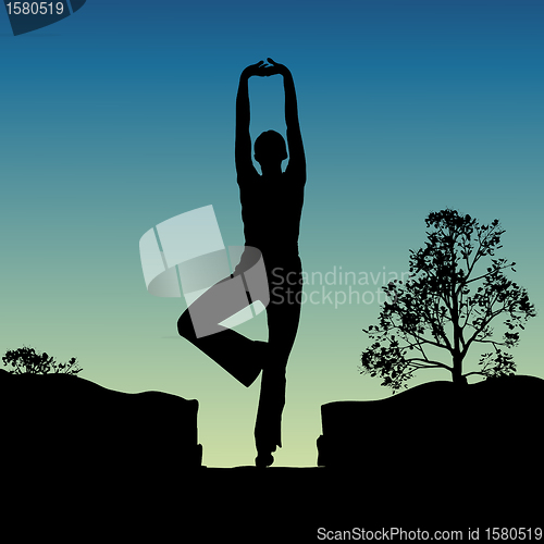 Image of silhouette view of human doing yoga, standing position