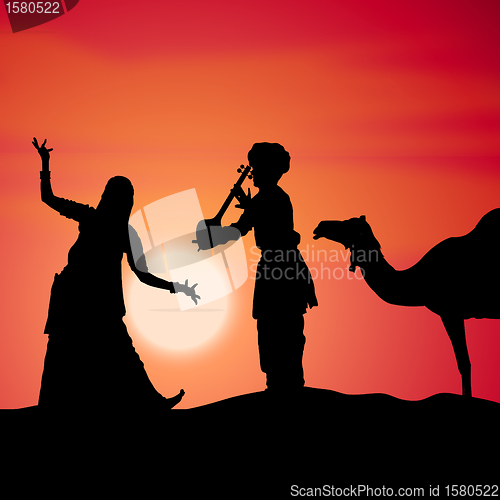 Image of silhouette view of people performing folk dance and music, india