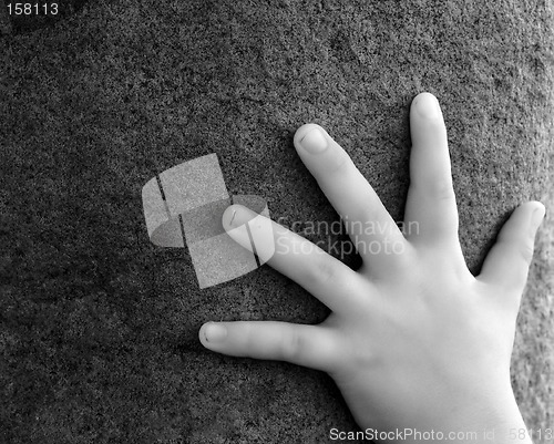 Image of Hand on Stone