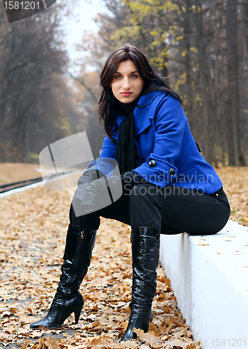 Image of Young woman in the autumn park