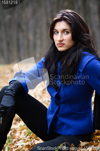 Image of Young woman in the autumn park