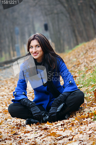 Image of Young woman in the autumn park