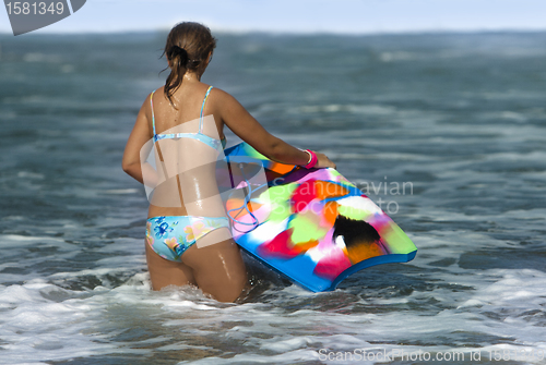Image of Woman with bodyboard  in the sea 