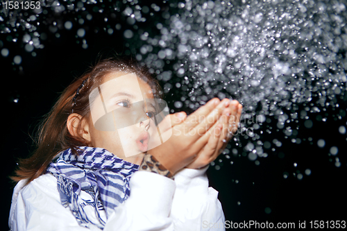 Image of Girl Blowing Snow 