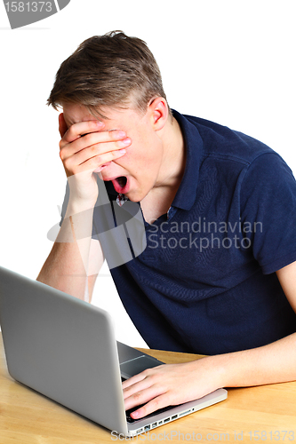 Image of Teenage boy working on the laptop