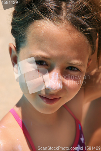 Image of girl with sunscreen in her nouse 