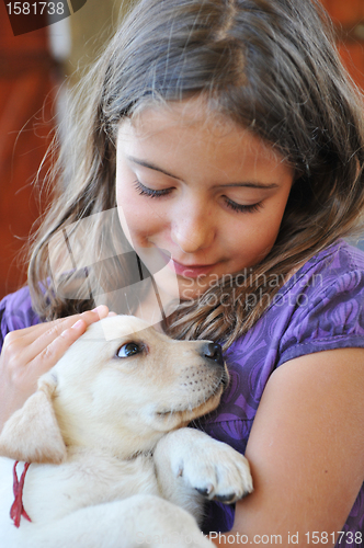 Image of puppy labrador retriever and little girl