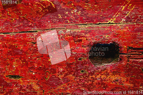 Image of grunge park bench board painted red background 