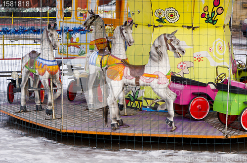 Image of amusement park carousel entertain cars horses 