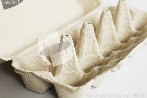 Image of empty grey cardboard egg carton 