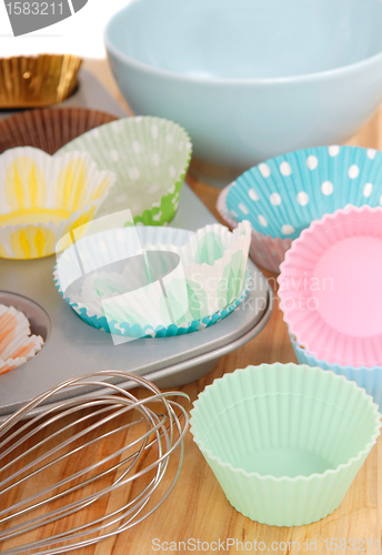 Image of Variety of cupcake liners with wire whisk