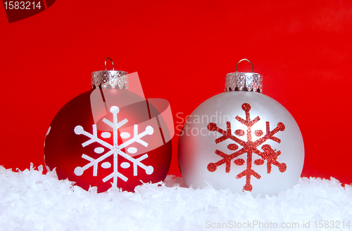 Image of Two Christmas ornaments in snow