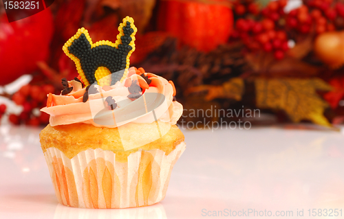 Image of Halloween cupcake with fall foliage