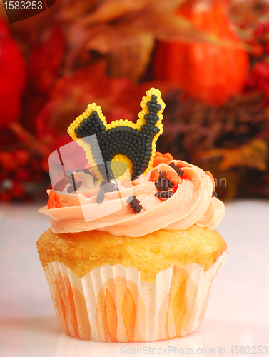 Image of Halloween cupcake with fall foliage