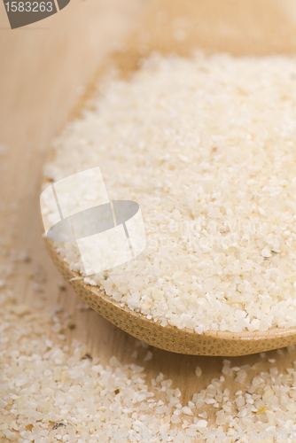 Image of Fresh grits on a wooden spoon