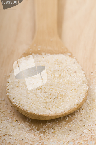 Image of Fresh grits on a wooden spoon