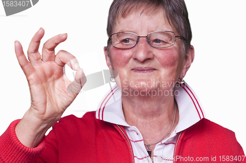 Image of pensioner with sign all okay