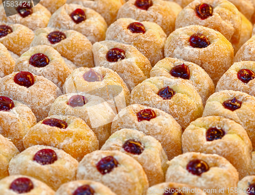 Image of Donuts with powdered sugar on a tray