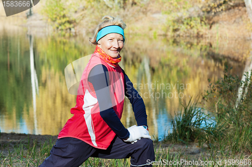 Image of Woman making of the stretching in full nature 