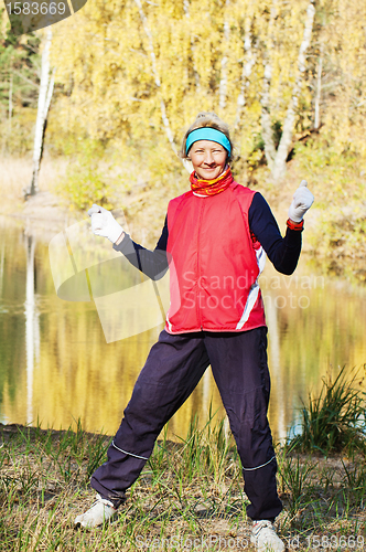 Image of Woman making of the stretching in full nature 