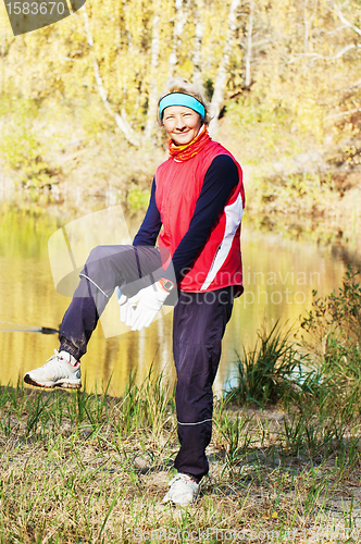 Image of Woman making of the stretching in full nature 